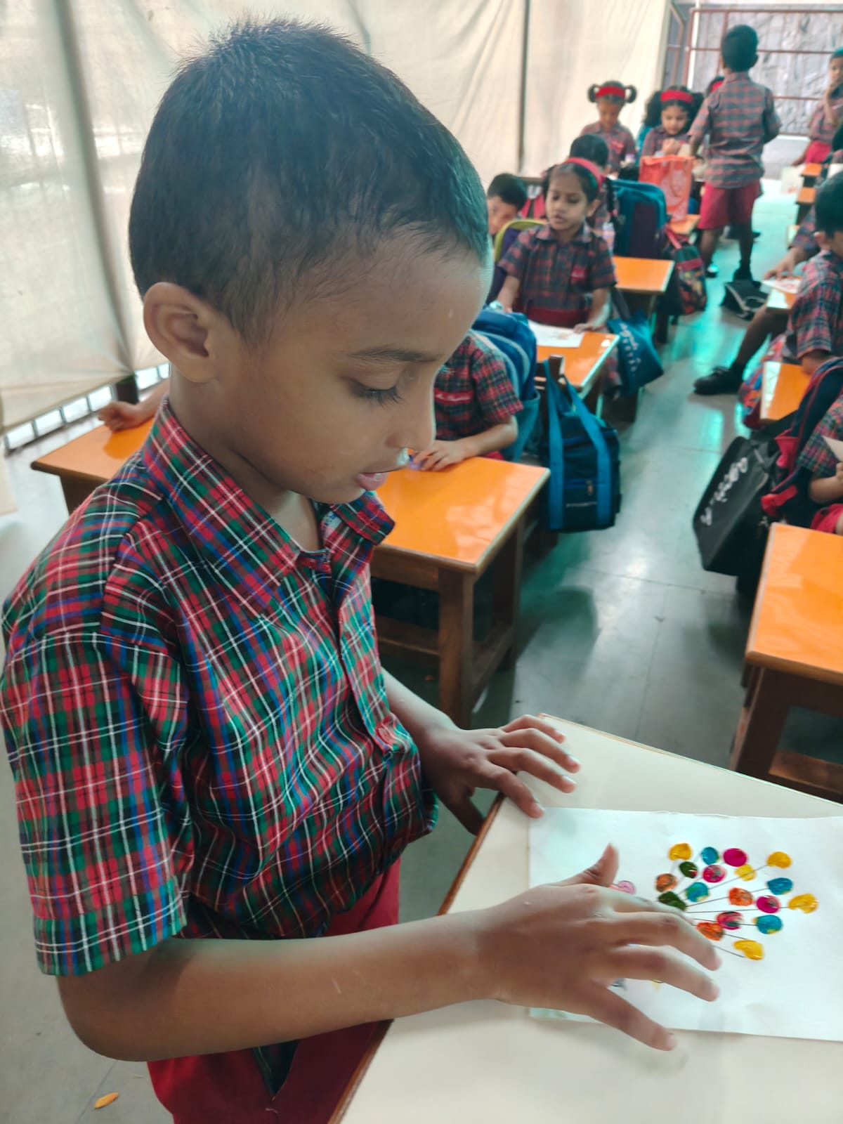 UKG - Child displaying fingerprint balloons card